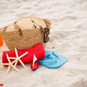 bag and beach accessories kept on sand