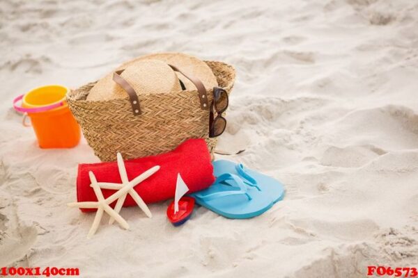 bag and beach accessories kept on sand