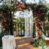 wedding altar made of colorful spearworts and white curtain stan