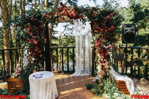 wedding altar made of colorful spearworts and white curtain stan