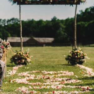 square wedding altar decorated with bouquets stands on the end o