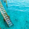 wood stair into the sea of tropical maldives island .