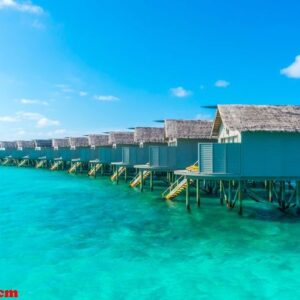 water villas over calm sea in tropical maldives island .