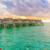 beautiful water villas in tropical maldives island at the sunset