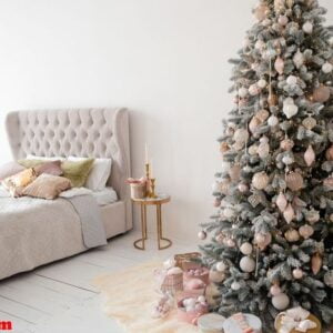 decorated christmas tree in room with bed.