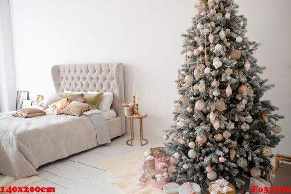 decorated christmas tree in room with bed.