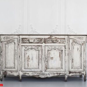 ancient white commode bureau with paint peeled off on luxury wall design bas relief stucco mouldings roccoco elements