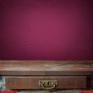 empty wooden table against a violet wall.