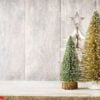 artificial christmas tree on a wooden background.