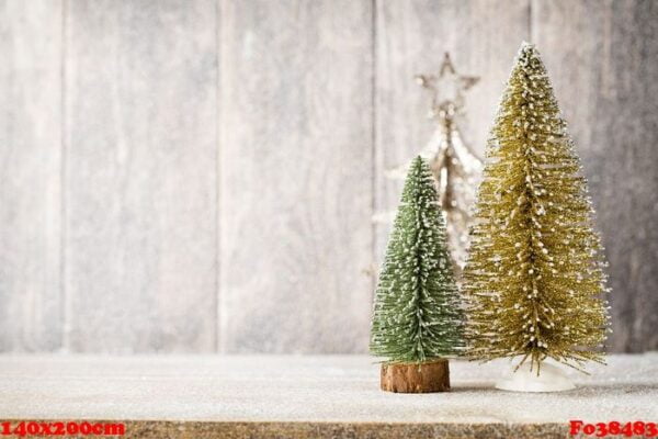 artificial christmas tree on a wooden background.