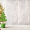 artificial christmas tree on a wooden background.