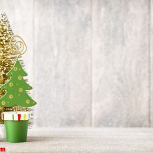 artificial christmas tree on a wooden background.