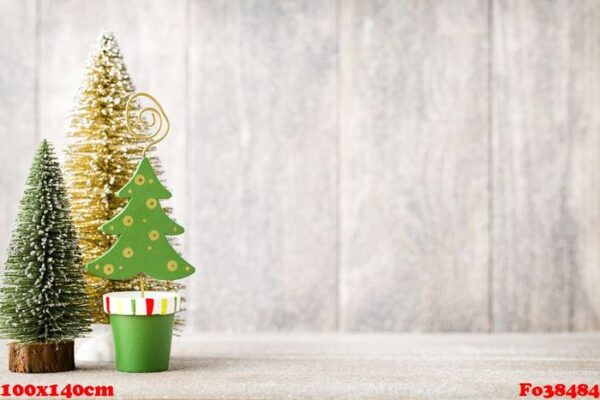 artificial christmas tree on a wooden background.