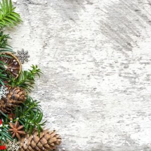 christmas background with fir tree branches, food decorations, pine cones