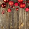 christmas background with red toys and decorations on a wooden table. christmas card. baner. flat layer. top view with copy space.