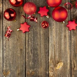 christmas background with red toys and decorations on a wooden table. christmas card. baner. flat layer. top view with copy space.