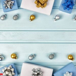 christmas composition, copy space. silver and gold christmas balls, blue and white gift boxes decorated with bows. festive layout.