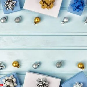 christmas composition, copy space. silver and gold christmas balls, blue and white gift boxes decorated with bows. festive layout.