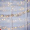 christmas decoration on the wall. wooden christmas garland and lanterns.