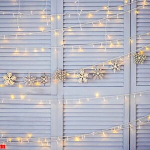 christmas decoration on the wall. wooden christmas garland and lanterns.