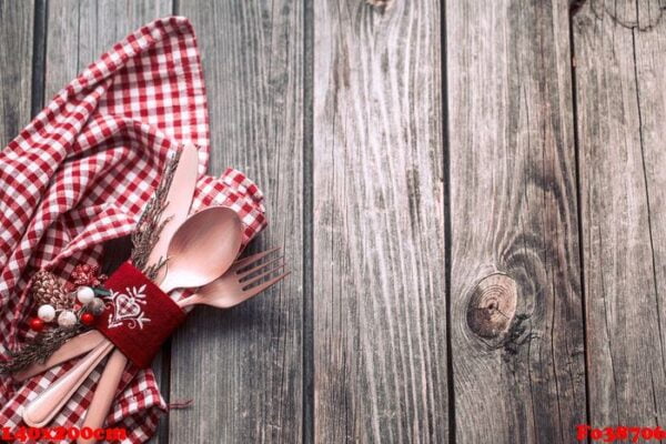 christmas dinner cutlery with decor on a wooden background