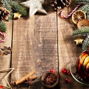 christmas mulled wine with spices on a wooden rustic table.