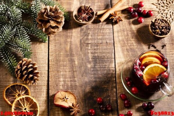 christmas mulled wine with spices on a wooden rustic table.