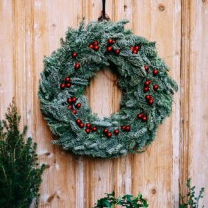 christmas wreath of fir branches on a wooden door.