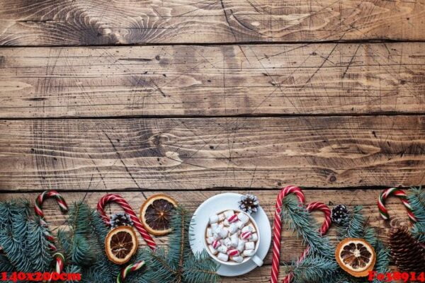 a cup of hot chocolate with marshmallows. christmas tree and decorations, cane caramel and oranges nuts wooden background copy space.