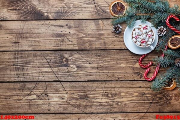 a cup of hot chocolate with marshmallows. christmas tree and decorations, cane caramel and oranges nuts wooden background copy space.