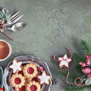 flat lay with xmas decorations in green and red with frosted ber