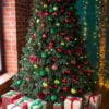 green christmas tree decorated with christmas gifts and a garland. new year.