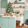 interior light kitchen with christmas decor and tree. turquoise colored kitchen in classic style. christmas in the kitchen. bright kitchen in mint and white shades with christmas.