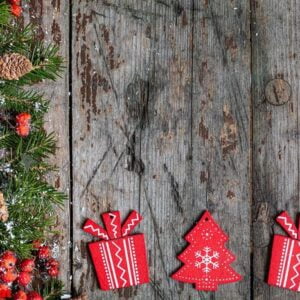 merry christmas and happy holidays greeting card, frame, banner. new year. happy new year card with snow on wooden background. winter xmas holiday theme. flat lay.