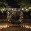 beautiful photozone with big wreath decorated with greenery and