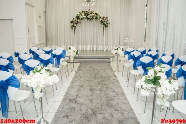 bright room for weddings. rows of guest chairs decorated with blue cloth