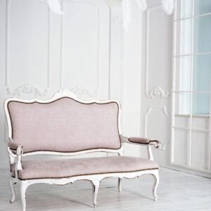 classical white interior with pink sofa.