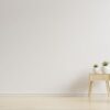 colorful interior with a pink armchair on empty white wall background.