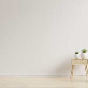 colorful interior with a pink armchair on empty white wall background.