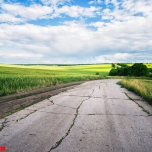 cracked asphalt road in the field