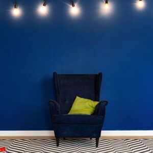 dark blue arm chair against blue wall in modern living room