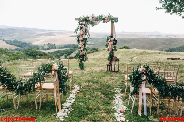 italian wedding decoration. green eucalyptus, oranges and pink f