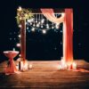 night wedding ceremony. the wedding is decorated with an arch in