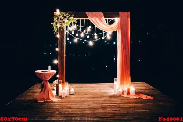 night wedding ceremony. the wedding is decorated with an arch in