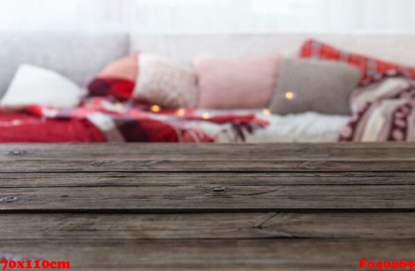 old wooden table on background sofa with pillows and plaids