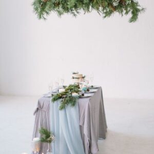 wedding. banquet. the chairs and table for guests, decorated with candles, served with cutlery and crockery and covered with a tablecloth.