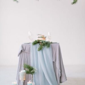 modern interior design. beautiful vintage dining table with decorations, flowers, candles and laying near the window. loft, botanic, rustic style. table set for an event, party, date or wedding.