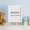 mock up poster frame with cute teddy bear for a boy baby shower