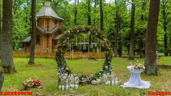 arch for a wedding ceremony in a pine forest. church. candles in decorated jars. newlyweds. wedding decorations.