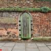 medieval door on a weathered stony wall.